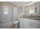 Bathroom with new vanity, subway tile tub surround and mirror at 925 67Th S St, St Petersburg, FL 33707