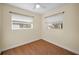 Bedroom features laminated wood floors, fresh paint, ceiling fan and two windows at 925 67Th S St, St Petersburg, FL 33707