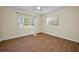 Bedroom features laminated wood floors, fresh paint, ceiling fan and two windows at 925 67Th S St, St Petersburg, FL 33707