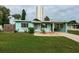 Charming light green house with a well-maintained lawn and driveway at 925 67Th S St, St Petersburg, FL 33707