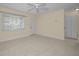 Bright living room with tile floors, neutral paint, a ceiling fan, and a large window with blinds at 925 67Th S St, St Petersburg, FL 33707