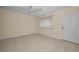 Bright living room with tile floors, neutral paint, a ceiling fan, and a large window with blinds at 925 67Th S St, St Petersburg, FL 33707