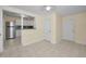 Bright living space with neutral paint, tile floors, and an open view into the kitchen at 925 67Th S St, St Petersburg, FL 33707