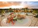 Community pool and playground view at sunset at 9354 Runaway Breeze Dr, Land O Lakes, FL 34637