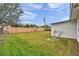 Backyard with green grass and a partial view of the house at 9850 55Th N Way, Pinellas Park, FL 33782