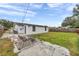 Backyard view of the house with patio and grass at 9850 55Th N Way, Pinellas Park, FL 33782