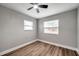 Bright bedroom with wood-look floors and ceiling fan at 9850 55Th N Way, Pinellas Park, FL 33782