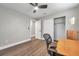 Bedroom with wood-look flooring, built-in shelving, and a door to another room at 9850 55Th N Way, Pinellas Park, FL 33782