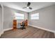 Well-lit bedroom featuring wood-look flooring and a workspace at 9850 55Th N Way, Pinellas Park, FL 33782