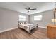 Bedroom with ceiling fan, wood-look flooring, and a dresser at 9850 55Th N Way, Pinellas Park, FL 33782