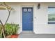 Blue front door and white brick exterior at 9850 55Th N Way, Pinellas Park, FL 33782