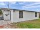 White house exterior with a blue door and yard at 9850 55Th N Way, Pinellas Park, FL 33782