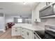 Stylish kitchen with white cabinets, stainless steel appliances and quartz countertops at 9850 55Th N Way, Pinellas Park, FL 33782