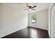 Bedroom with dark hardwood floors, ceiling fan and window at 10509 Massimo Dr, Wimauma, FL 33598