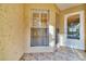 Enclosed patio with tiled floor and window at 1185 Woodfield Ct, Palm Harbor, FL 34684