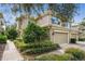 Charming two-story townhome with manicured landscaping, a two-car garage, and neutral colors at 13215 San Blas Loop, Largo, FL 33774