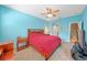 Spacious main bedroom with blue walls, neutral carpet, and ensuite bathroom at 13215 San Blas Loop, Largo, FL 33774