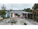 Charming single-story home with pink accents and a carport at 14236 Palm St, Madeira Beach, FL 33708