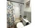 Clean bathroom with a shower/tub combo and a tropical shower curtain at 15906 Country Farm Pl, Tampa, FL 33624