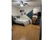 Bedroom with hardwood floors and gray bedding at 15906 Country Farm Pl, Tampa, FL 33624