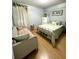 Bedroom with light green bedding and a sitting area at 15906 Country Farm Pl, Tampa, FL 33624