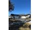 Gray house with black roof, driveway, and landscaping at 15906 Country Farm Pl, Tampa, FL 33624
