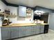 Modern kitchen with gray cabinets, butcher block countertops, and floating shelves at 15906 Country Farm Pl, Tampa, FL 33624