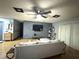 Living room features a gray accent wall, comfy couch, and hardwood floors at 15906 Country Farm Pl, Tampa, FL 33624