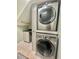 Bright laundry room with stacked LG washer and dryer at 16754 Ivy Lake Dr, Odessa, FL 33556