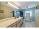 Bright bathroom with a large mirror, vanity with sink, and tiled floor at 1723 Wolf Laurel Dr, Sun City Center, FL 33573