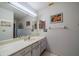 Bathroom with a long vanity, large mirror, and tiled floor at 1723 Wolf Laurel Dr, Sun City Center, FL 33573