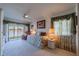 Bedroom with a day bed, ceiling fan, and a view of the lake at 1723 Wolf Laurel Dr, Sun City Center, FL 33573