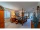 Spacious bedroom with a four poster bed, neutral carpet, and a sliding glass door leading to the outside at 1723 Wolf Laurel Dr, Sun City Center, FL 33573