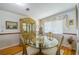 Classic dining room with wood floors and cabinet with glass table and chairs at 1723 Wolf Laurel Dr, Sun City Center, FL 33573