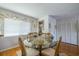 Dining area features glass table, wood floors, and lots of natural light with door for easy access at 1723 Wolf Laurel Dr, Sun City Center, FL 33573