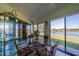 Florida room features views of the pond, a glass table, and a lovely curio cabinet at 1723 Wolf Laurel Dr, Sun City Center, FL 33573