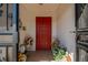 Welcoming front door with a decorative window, surrounded by flowers, plants, and decor at 1723 Wolf Laurel Dr, Sun City Center, FL 33573