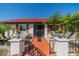 Inviting front entrance with a brick walkway, decorative railings, and landscaping with potted plants at 1723 Wolf Laurel Dr, Sun City Center, FL 33573