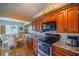 Kitchen features updated appliances, granite counters, and a breakfast area for casual dining at 1723 Wolf Laurel Dr, Sun City Center, FL 33573