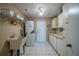 Laundry room with washer, dryer, utility sink, and plenty of cabinet storage at 1723 Wolf Laurel Dr, Sun City Center, FL 33573