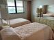 Two twin beds in a bright bedroom with window and dresser at 17580 Gulf Blvd # 320, Redington Shores, FL 33708