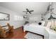 Bright bedroom with hardwood floors and white bedding at 1761 Eaton Ne Dr, Clearwater, FL 33756