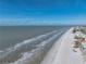 Beachfront aerial view showcasing ocean, beach, and buildings at 19440 Gulf Blvd # 301, Indian Rocks Beach, FL 33785