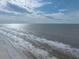 Drone shot of a wide sandy beach with ocean waves at 19440 Gulf Blvd # 301, Indian Rocks Beach, FL 33785