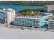 Aerial view of teal building near beach and waterway at 19440 Gulf Blvd # 301, Indian Rocks Beach, FL 33785