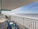 Oceanfront balcony with comfortable seating at 19440 Gulf Blvd # 301, Indian Rocks Beach, FL 33785
