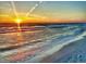Stunning sunset over calm ocean waves on sandy beach at 19440 Gulf Blvd # 301, Indian Rocks Beach, FL 33785