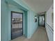 Condo hallway with teal walls and access to unit at 19440 Gulf Blvd # 301, Indian Rocks Beach, FL 33785