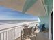 Relaxing oceanfront balcony with chairs and table at 19440 Gulf Blvd # 301, Indian Rocks Beach, FL 33785