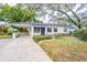 Charming ranch home with a landscaped front yard and covered entry at 2004 W Meadowbrook Ave, Tampa, FL 33612